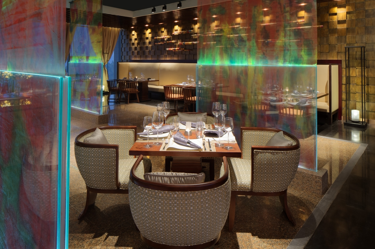 Signature restaurant at Rosewood St. Petersburg with arched windows, set tables and soft evening light