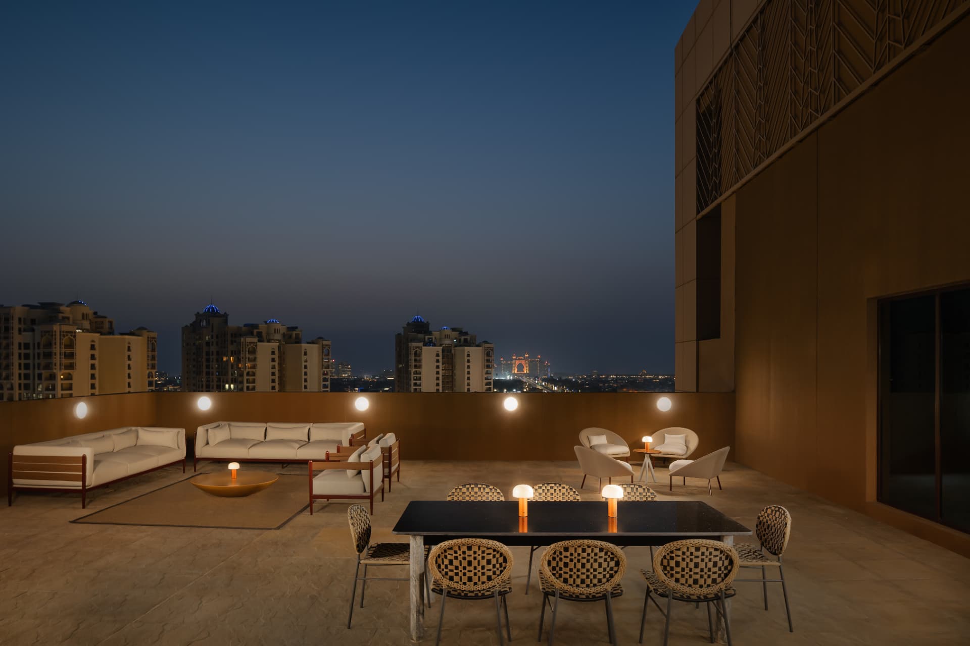 Cheval Maison The Palm rooftop terrace after the photography refresh — blue hour HDR with lit lamps and Dubai skyline