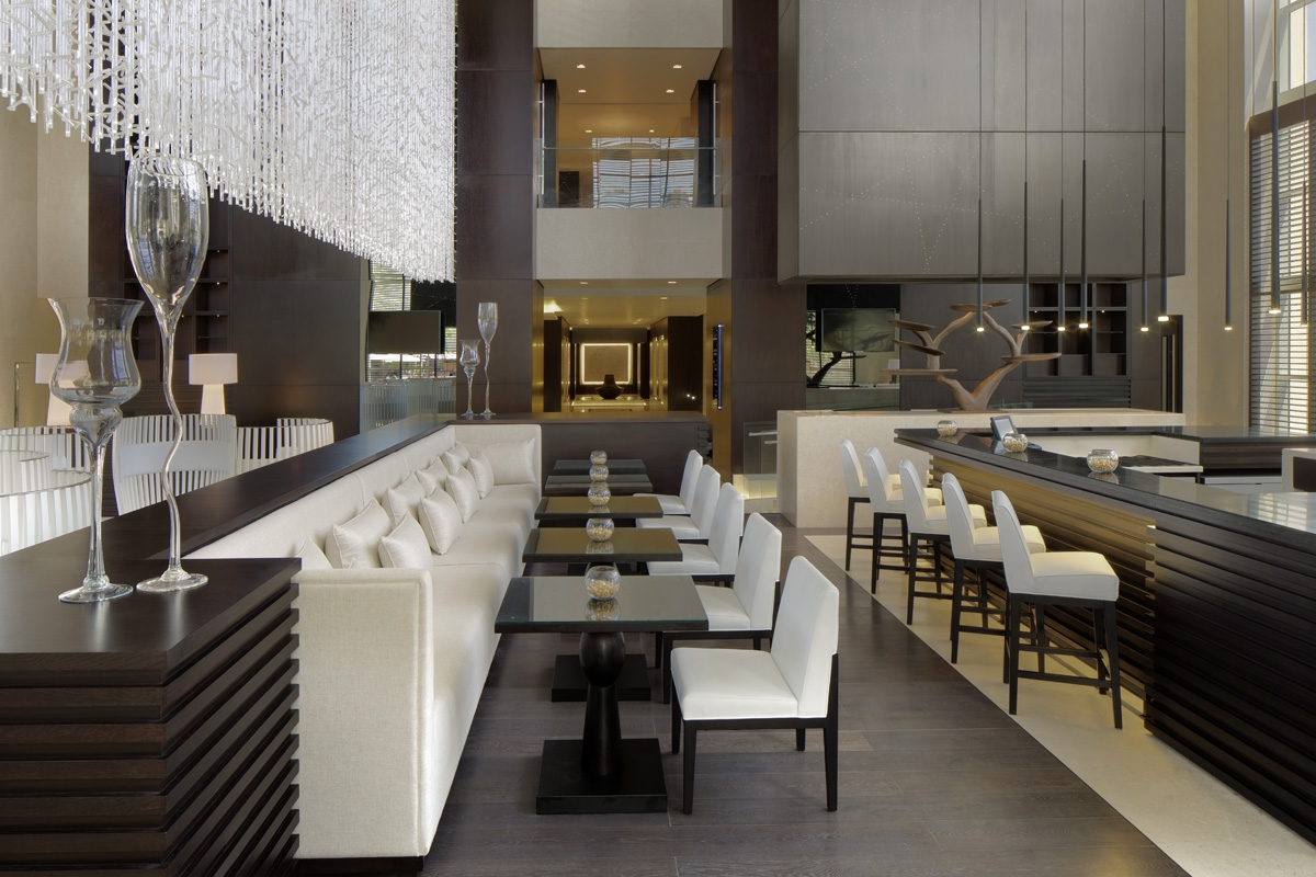 Le Méridien lobby lounge and bar with clustered armchairs, marble surfaces and layered pools of light