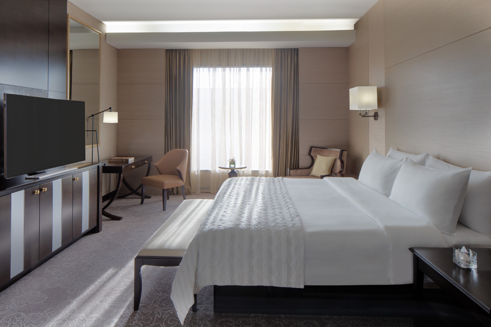 King guestroom at Hyatt Regency with crisp white linen, writing desk and soft window light