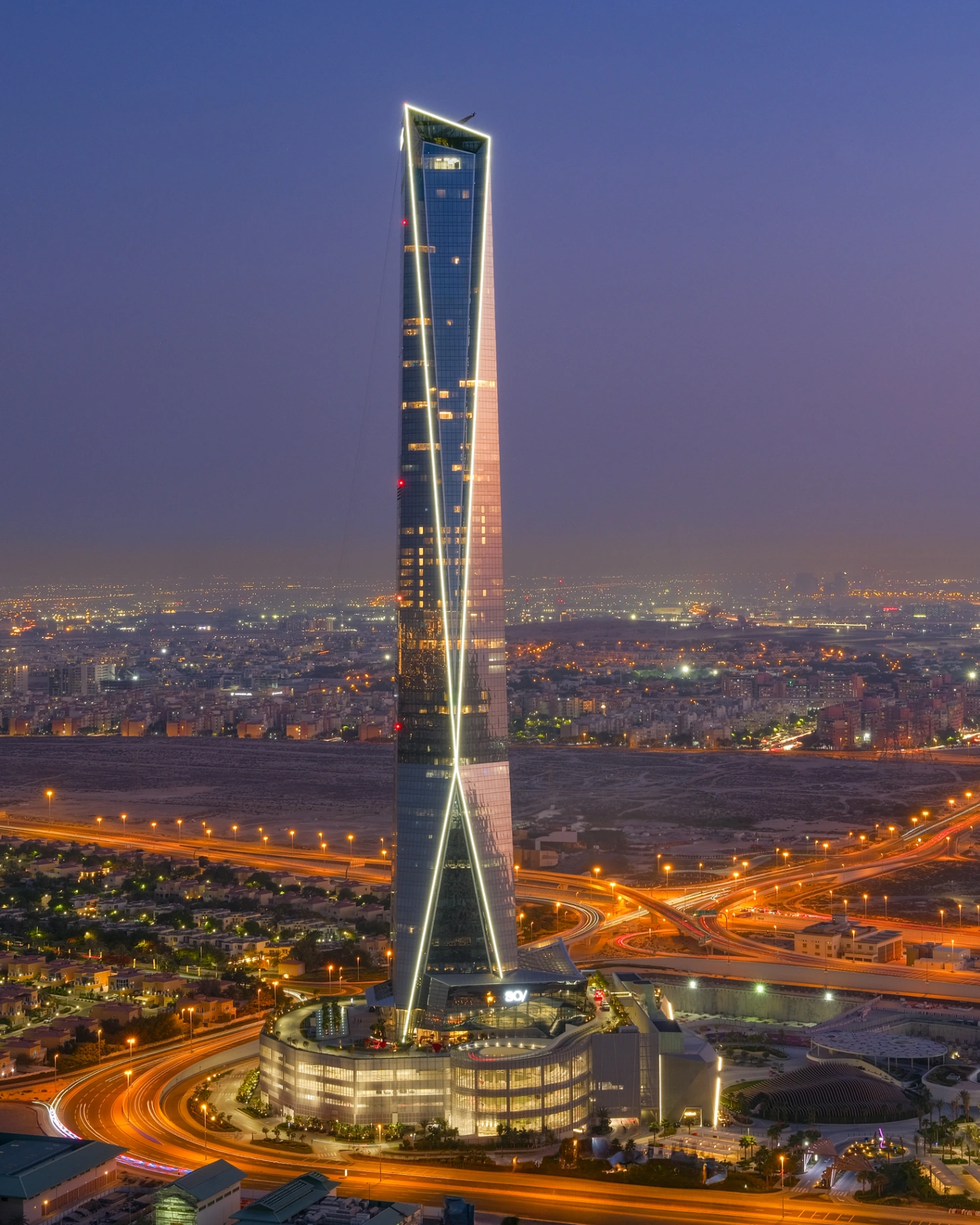 Contemporary Dubai tower photographed at dusk against a deepening sky