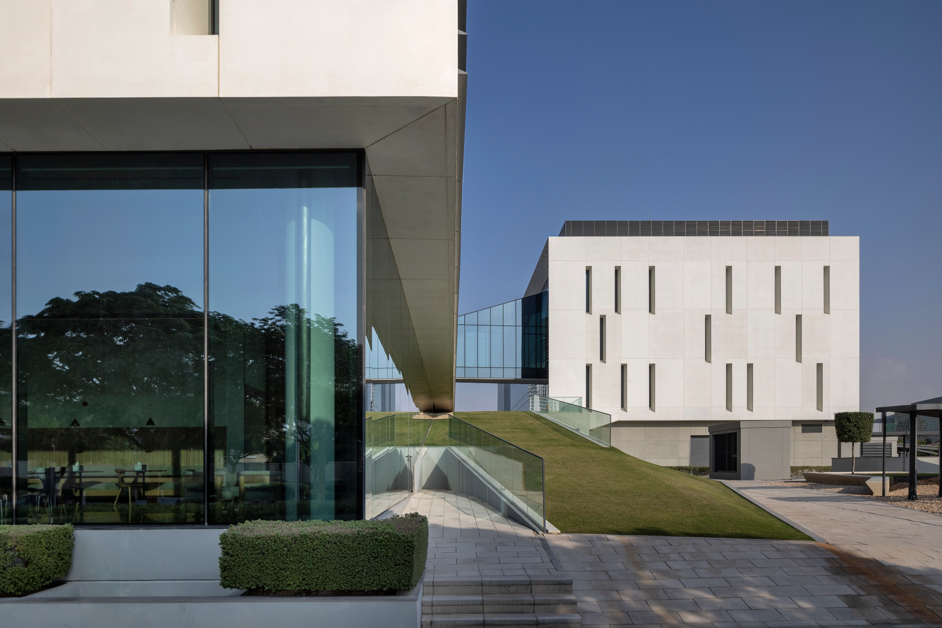 Institutional campus facade photographed frontally with balanced sky and shadow