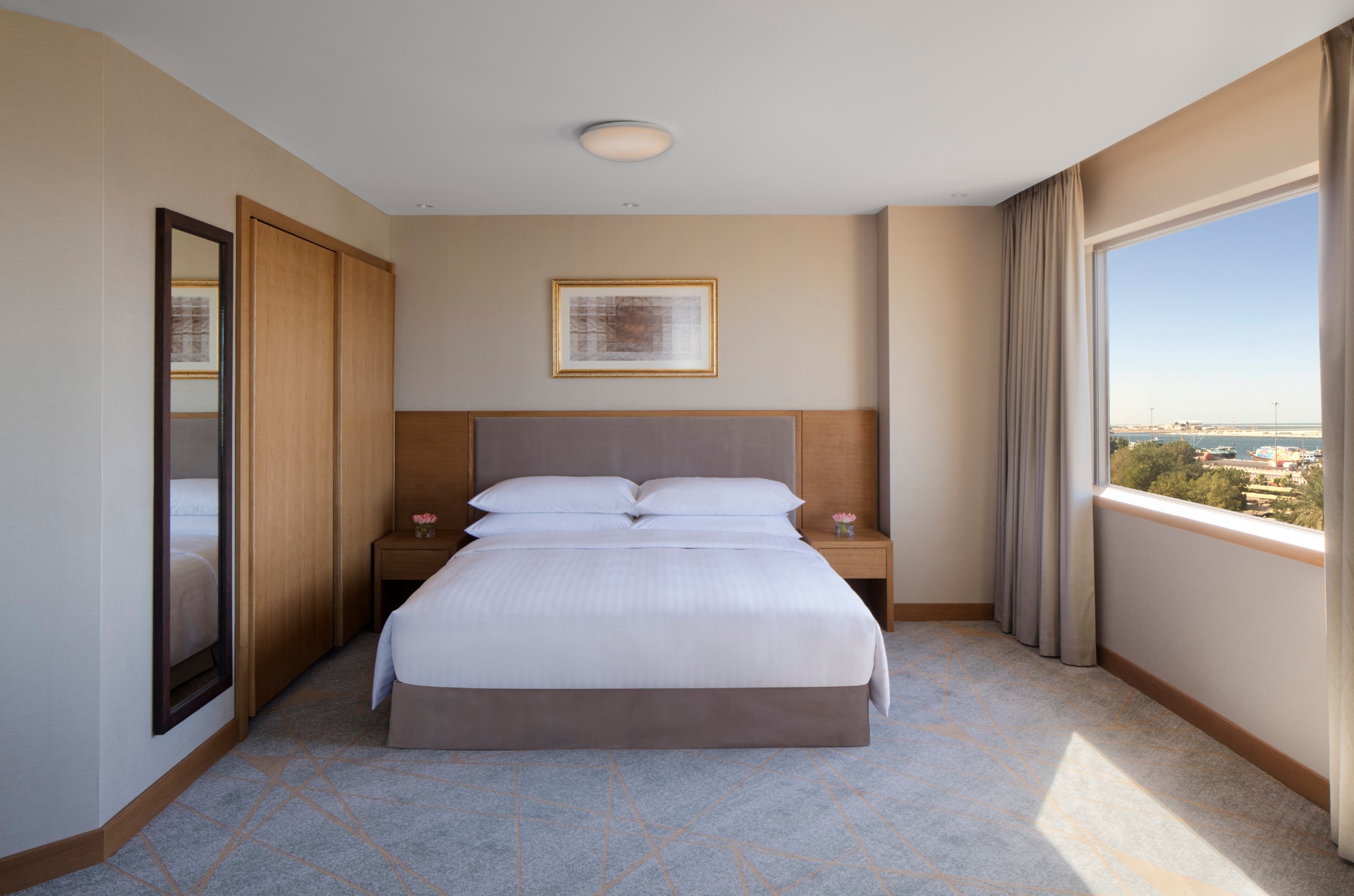 Harbour view guestroom at Hyatt Regency looking out over the water through full-height glazing